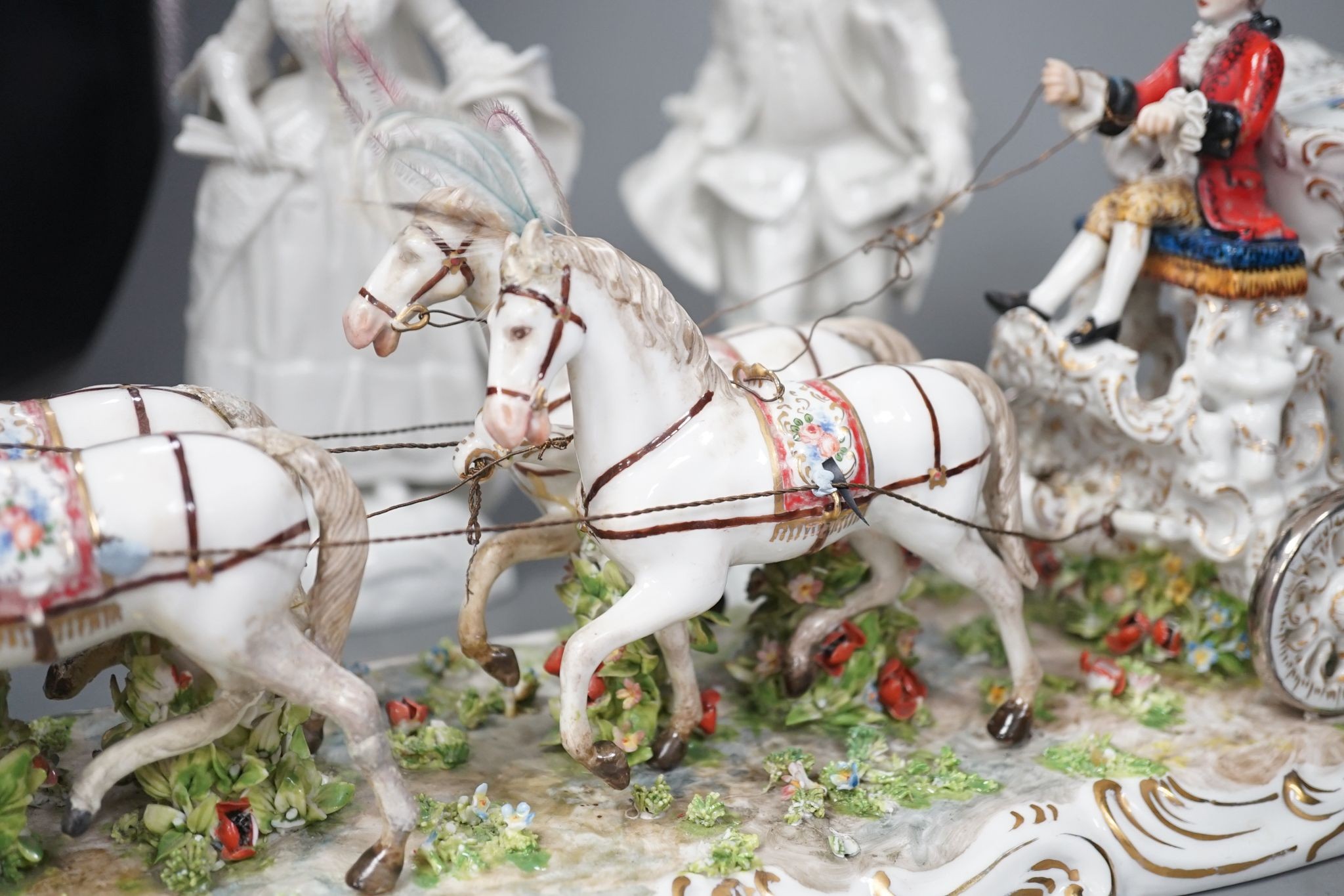 A large Italian porcelain carriage group and a pair of Italian white porcelain figure of a lady and a man 54cm